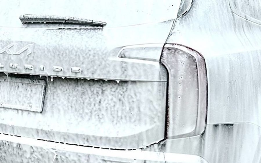 SUV covered in thick snow foam during a K&J Shine Works exterior detail